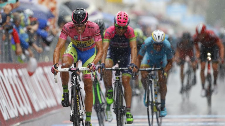 Spanish rider Alberto Contador crosses the finish line under heavy rain to place 2nd of the 12th stage of the 98th Giro d'Italia