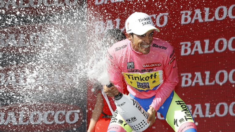 Spaniard Alberto Contador celebrates on the podium with the pink jersey on May 29, 2015 after the 19th stage of the 98th Giro d'Italia