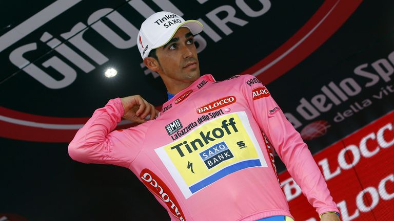 Alberto Contador  looks on on the podium as he celebrates retaining the overall leader's pink jersey after the 7th stage of the Giro d'Italia