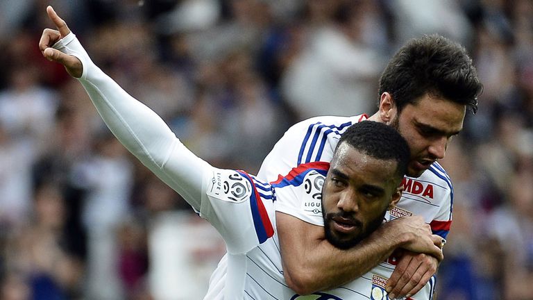 Lyon's French forward Alexandre Lacazette (L) celebrates with Lyon's French midfielder Clement Grenier (R) after 