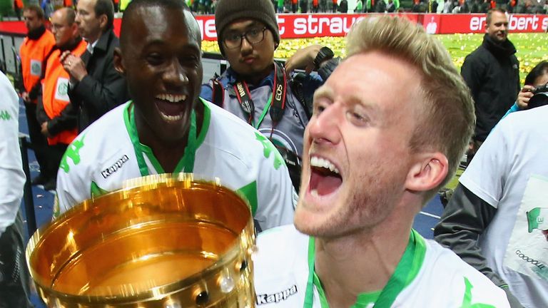 BERLIN, GERMANY - MAY 30:  Andre Schuerrle of Wolfsburg celebrates with the trophy after winning the 
