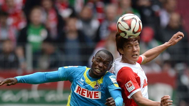 AUGSBURG, GERMANY - MAY 02: Anthony Ujah (L) of Koeln and Dong-Won Ji of Augsburg jump for a header 