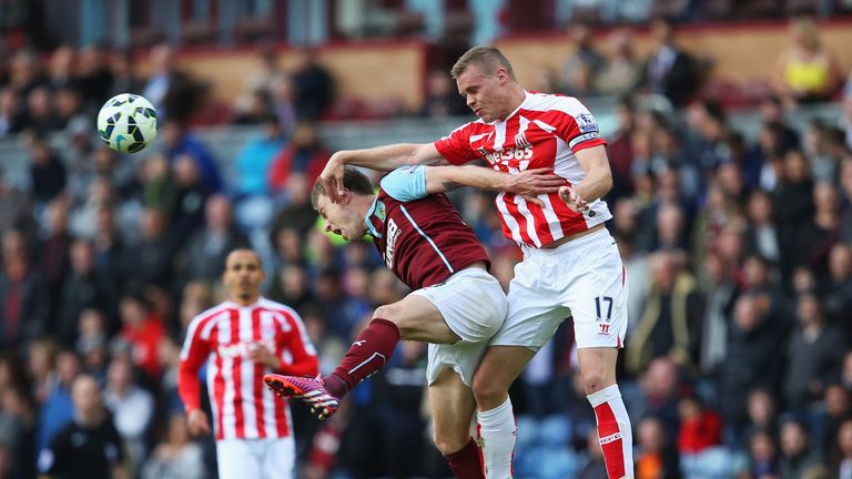 Burnley's Ashley Barnes and Ryan Shawcross of Stoke City compete for the ball.