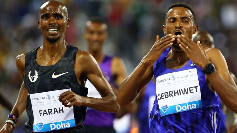 Hagos Gebrhiwet of Ethiopia (R) reacts as he win the 3000m competition ahead of Olympic champion Mo Farah (L)