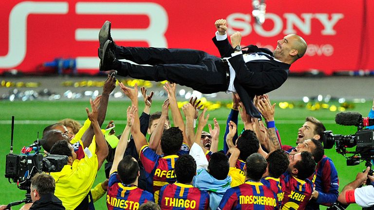 FC Barcelona's Spanish coach Josep Guardiola is thrown in the air in celebration after Barcelona defeated Manchester United 3-1 during their UEFA Champions