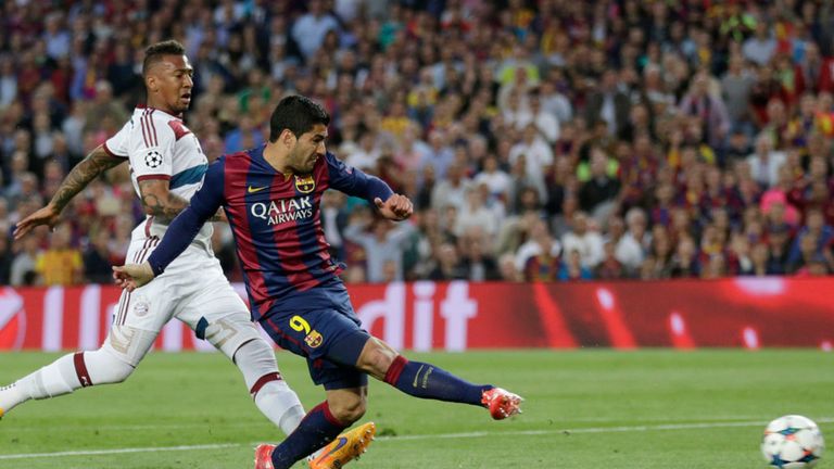 Barcelona's Luis Suarez shoots on the goal as Bayern's Jerome Boateng looks on