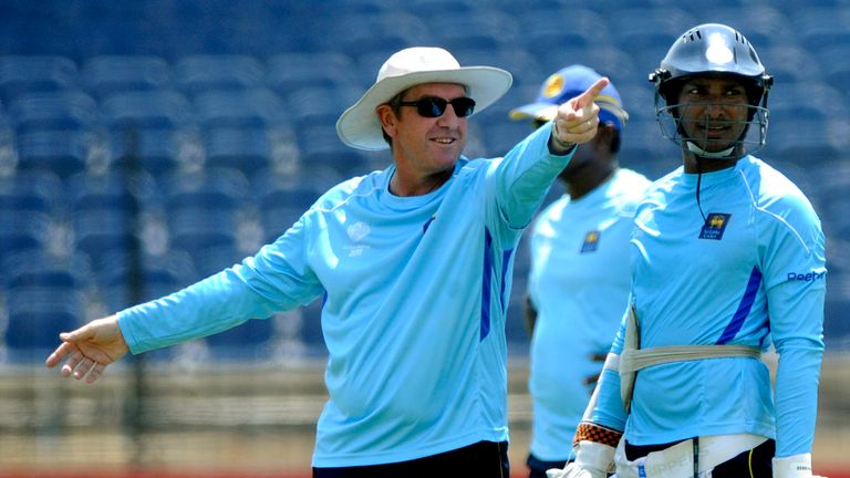 Sri Lankan cricket team coach Trevor Bayliss (L) and team captain Kumar Sangakkara (R) interact during a training session at the Suriyawewa Mahinda Rajapak