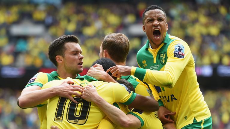 Cameron Jerome of Norwich City (10) is congratulated by Martin Olsson (23) and team mates as he scores