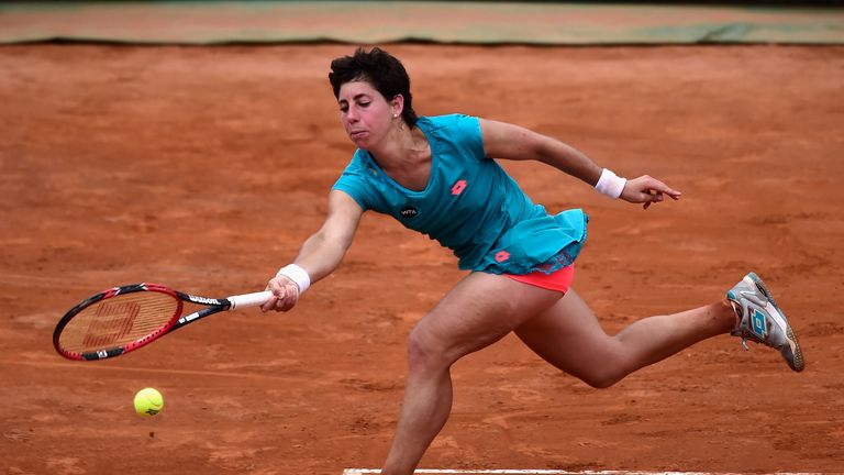 Carla Suarez Navarro of Spain stretches for a forehand during her Women's Semi Final against  Simona Halep 