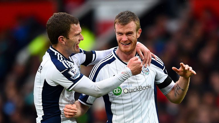 Chris Brunt (right) celebrates after his deflected free-kick flies into the Manchester United net