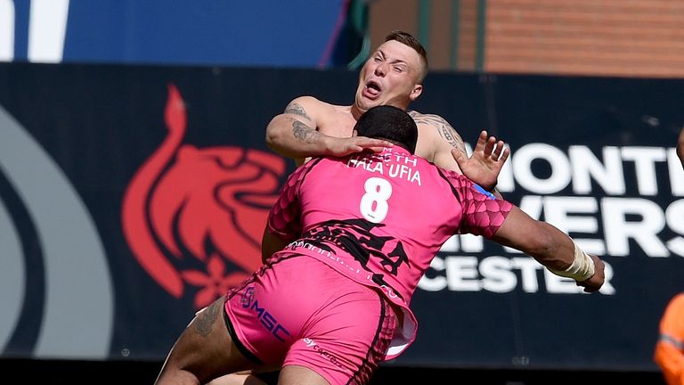 Chris Hala'ufia of London Irish tackles a streaker during the Leicester game