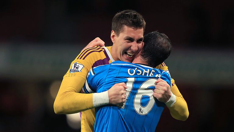 Sunderland goalkeeper Costel Pantilimon (left) and Sunderland's John O'Shea (right) embrace after the Barclays Premier League match at the Emirates Stadium