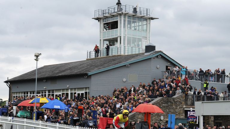 A horse is ridden to post at Cartmel Racecourse, Cumbria