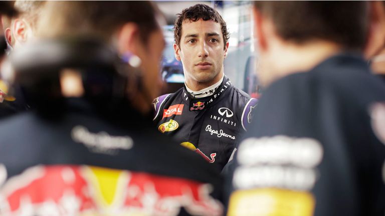 Daniel Ricciardo of Australia and Infiniti Red Bull Racing speaks with members of his team i