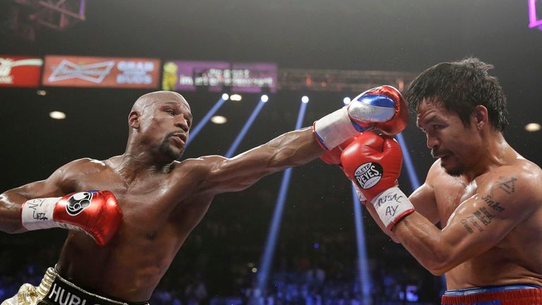Floyd Mayweather Jr., left, trades blows with Manny Pacquiao, from the Philippines, during their welterweight title fight on Saturday, May 2, 2015