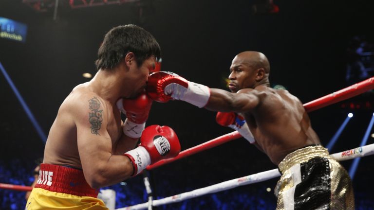 Floyd Mayweather Jr. (R) connects against (L) during their welterweight unification bout on May 2, 2015 at the MGM Grand Garden Arena in Las Vegas, Nevada.