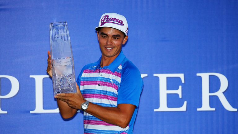 Rickie Fowler celebrates with the winner's trophy after the final round of THE PLAYERS Championship at the TPC Sawgrass Stadium course 