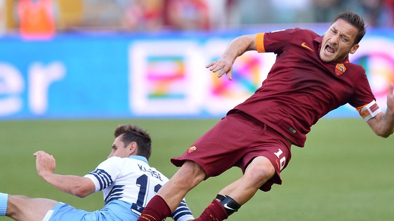 Roma's forward Francesco Totti (R) is tackled by Lazio's 