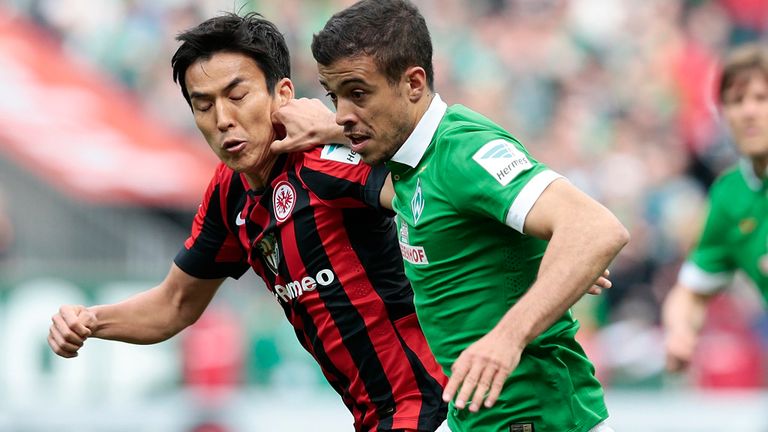 BREMEN, GERMANY - MAY 02:  Franco Di Santo (R) of Bremen and Makoto Hasebe (L) of Frankfurt compete for 