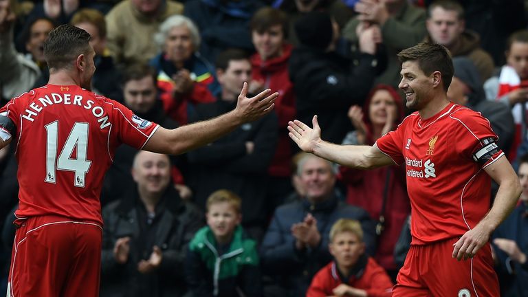 Liverpool's English midfielder Steven Gerrard (R) celebrates with Liverpool's English midfielder Jordan Hendersonnn