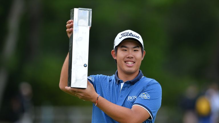 Byeong-hun An celebrates with the trophy after winning the BMW PGA Championship at Wentworth 