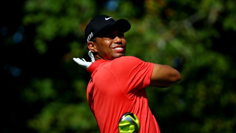 Tiger Woods drops his driver as he plays his shot from the seventh tee during the final round of THE PLAYERS Championship 