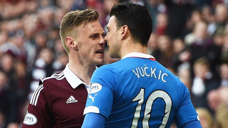Hearts' Kevin McHattie (left) clashes with Haris Vuckic
