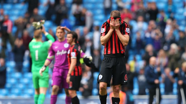 A dejected Clint Hill of QPR and teammates react following their team's relegation.