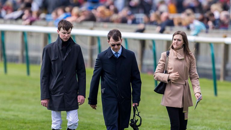 Trainer Aidan O' Brien (centre) walks the course with his jockey son Joseph and daughter Anna before the Charm Spirit Dahlia Stakes Race run during the QIP