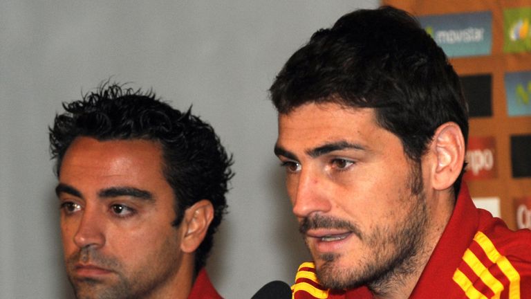 Spain's national soccer team player Xavi Hernandez (L)  looks on while his captain and goalkeeper Iker Casillas (R) speaks at a press conference 