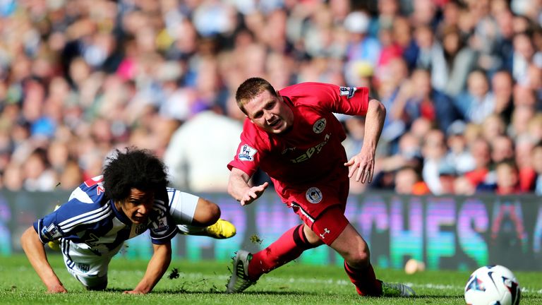 James McCarthy of Wigan is brought down by Isaiah Brown of West Bromwich during the Premier League match in May 2013 