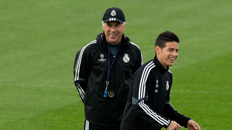 James Rodriguez (R) of Real Madrid shares a joke with head coach Carlo Ancelotti (L) during a training session.