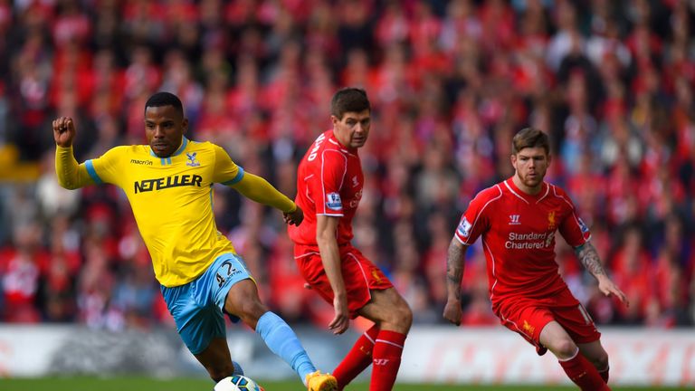 Jason Puncheon of Crystal Palace breaks away from Steven Gerrard and Alberto Moreno of Liverpool.