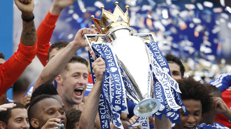 Chelsea defender John Terry holds up the Premier League trophy 