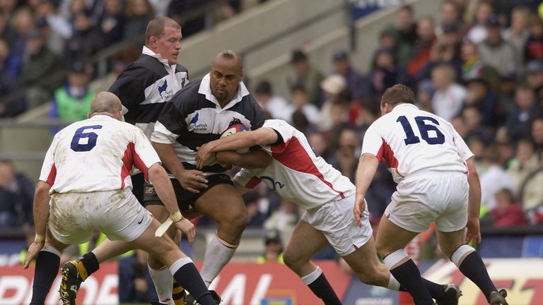 Barbarian Jonah Lomu battles with the England defence