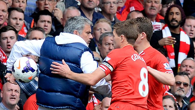 Chelsea manager Jose Mourinho keeps the ball away from Liverpool midfielder Steven Gerrard during the Premier League match in April 2014