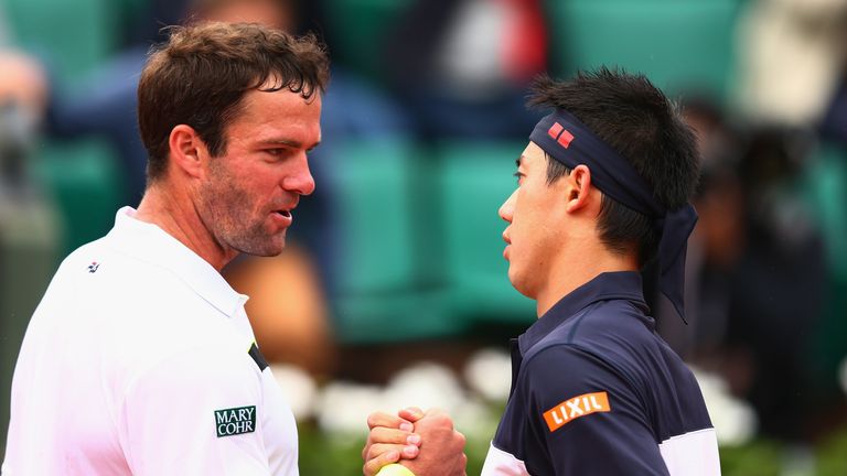 Teymuraz Gabashvili of Russia congratulates Kei Nishikori of Japan after their  Men's Singles match on day eight of the 2015 French Open at Roland Garros 
