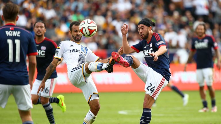 LOS ANGELES, CA - DECEMBER 07:  Juninho #19 of the Los Angeles Galaxy and Lee Nguyen #24 of the New England Revolution vie for the ball