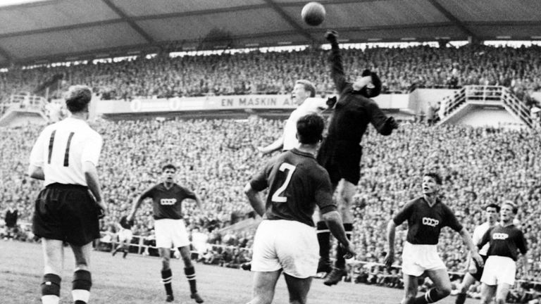 Goalkeeper Lev Yashin (black) from the Soviet Union boxes the ball away from an English player during the World Cup first round soccer match between the So