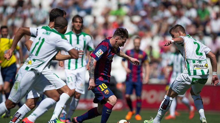 Lionel Messi (2ndR) of FC Barcelona competes for the ball with Aleksandar Pantic (R) of Cordoba CF during the La Liga match betwe