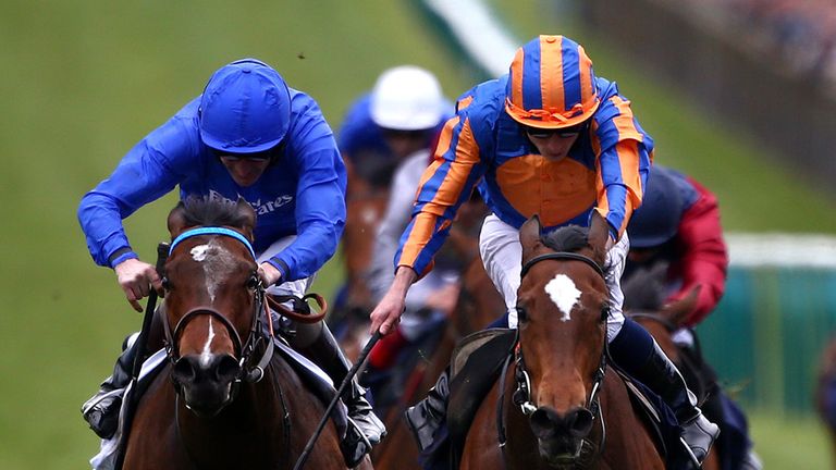 NEWMARKET, ENGLAND - MAY 03: Ryan Moore rides Legatissimo (C, orange and blue cap) to win TheQipco 1000 Guineas Stakes at Newmarket racecourse on May 03, 2