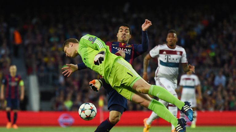 Luis Suarez of Barcelona and Manuel Neuer of Bayern Muenchen compete for the ball 