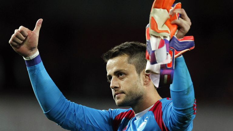 Swansea City's Polish goalkeeper Lukasz Fabianski acknowledges the crowd at the final whistle during the 