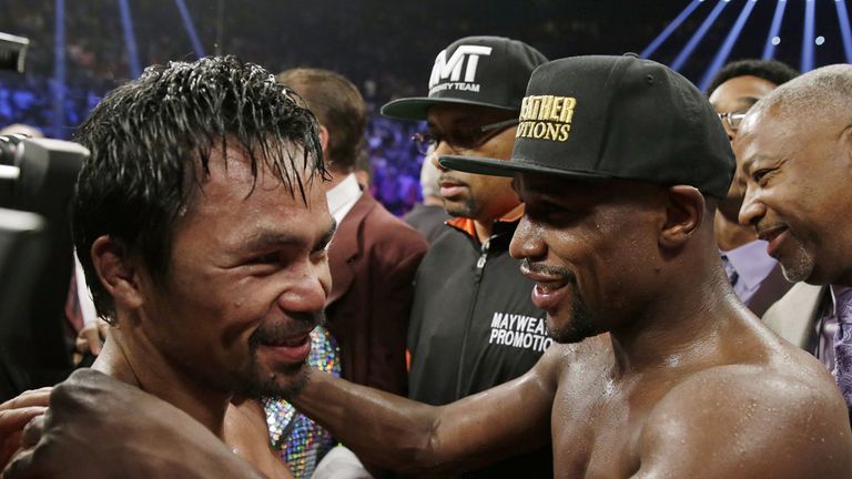 Manny Pacquiao and Floyd Mayweather Jr., embrace in the ring at the finish of their welterweight title fight