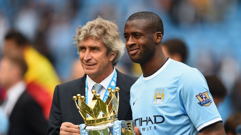 The Manchester City Manager Manuel Pellegrini and Yaya Toure pose with the trophy at the end of the Barclays Premier League 