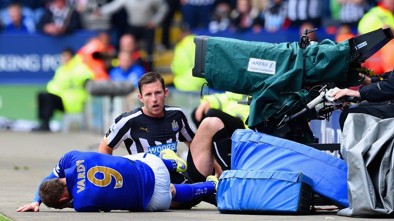 Mike Williamson and Jamie Vardy fall in a heap after the Newcastle man's challenge