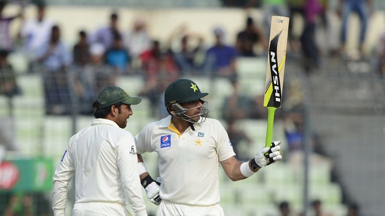 Pakistan captain Misbah-ul-Haq (R) reacts after scoring a half century (50 runs) as his teammate Sarfraz Ahmed looks on during the third day