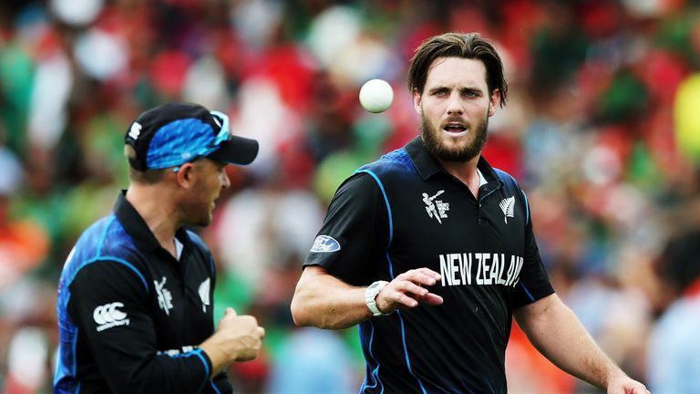 Mitchell McClenaghan of New Zealand catches the ball from teammate Brendon McCullum