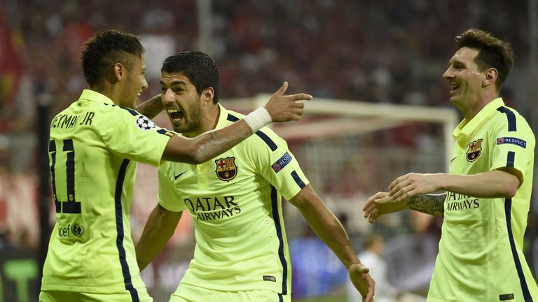 Barcelona's Brazilian forward Neymar celebrates scoring his second goal with Luis Suarez and Lionel Messi against Bayern Munich