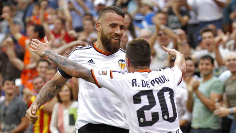 Valencia's Argentinian defender Nicolas Otamendi (L) celebrates with Valencia's Argentinian midfielder Rodrigo de Paul